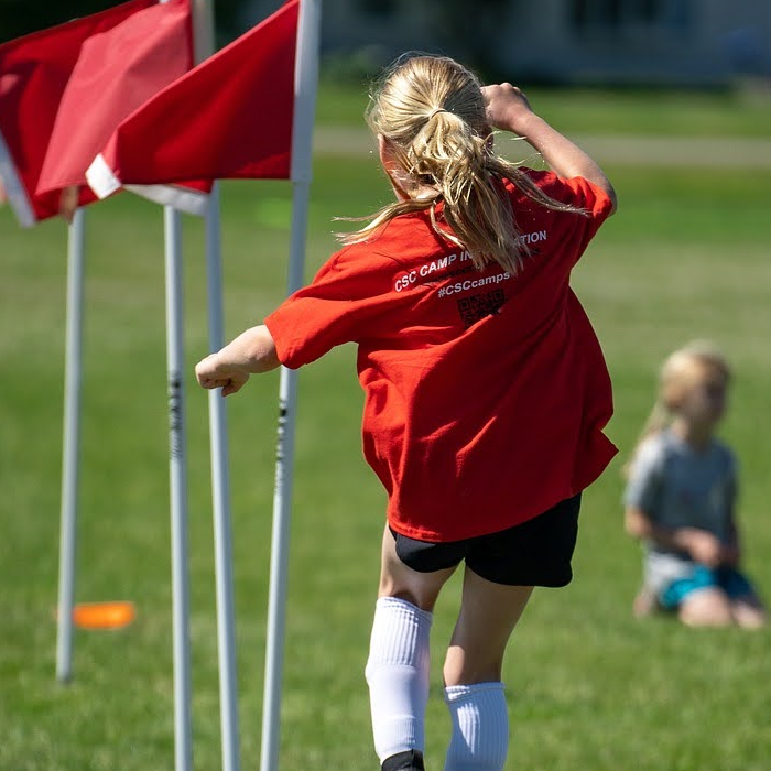 Kid playing soccer.